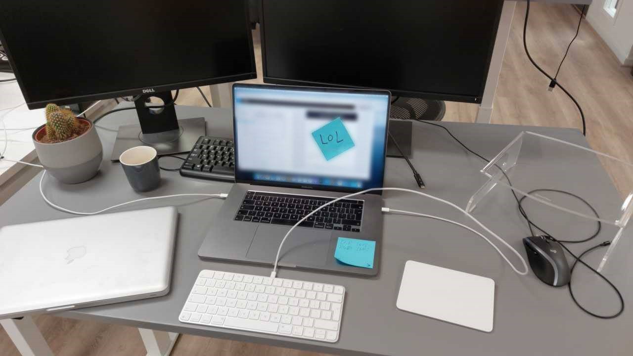 An unlocked laptop with a sticky note with lol on the screen